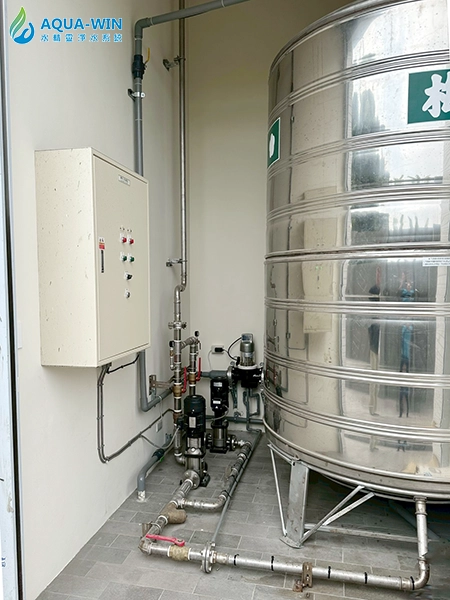 Whole-house water filtration system installed after rooftop water tank with booster pump integration