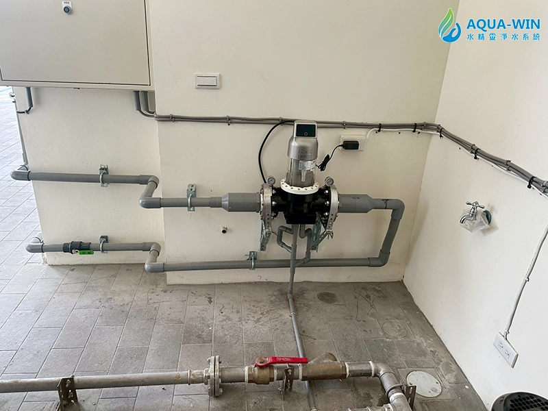 Front view of automatic backwash whole-house water filter with pressure gauges and drain outlet